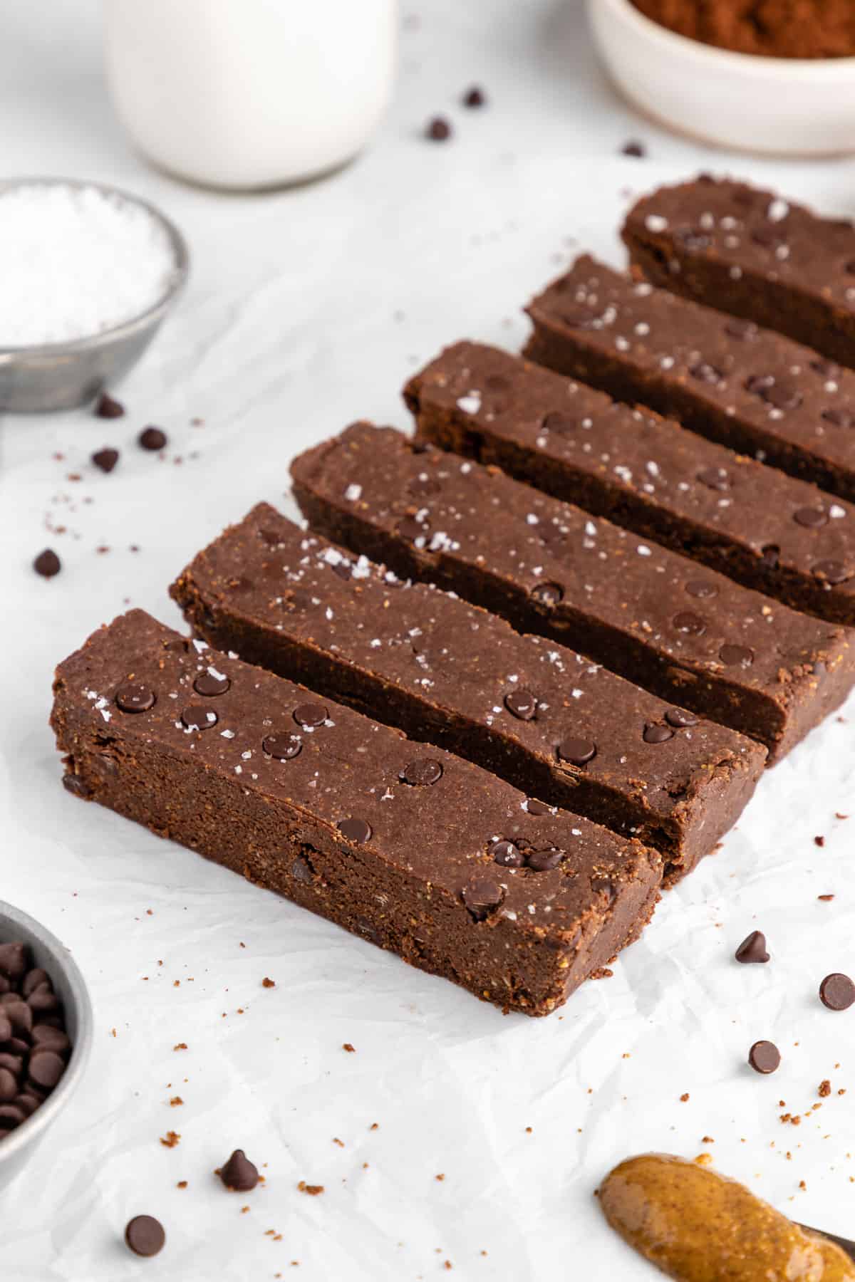 no-bake chocolate brownie protein bars on white parchment paper