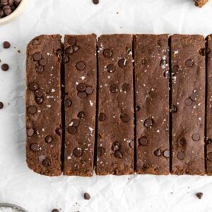 brownie protein bars with chocolate chips on white parchment paper