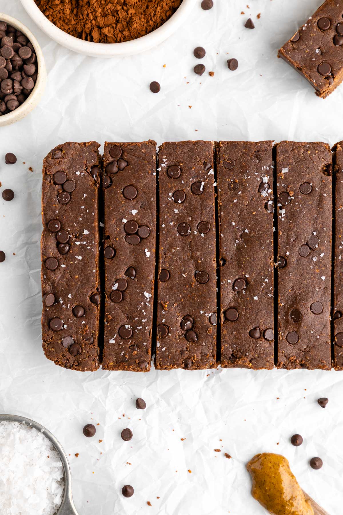 brownie protein bars with chocolate chips on white parchment paper