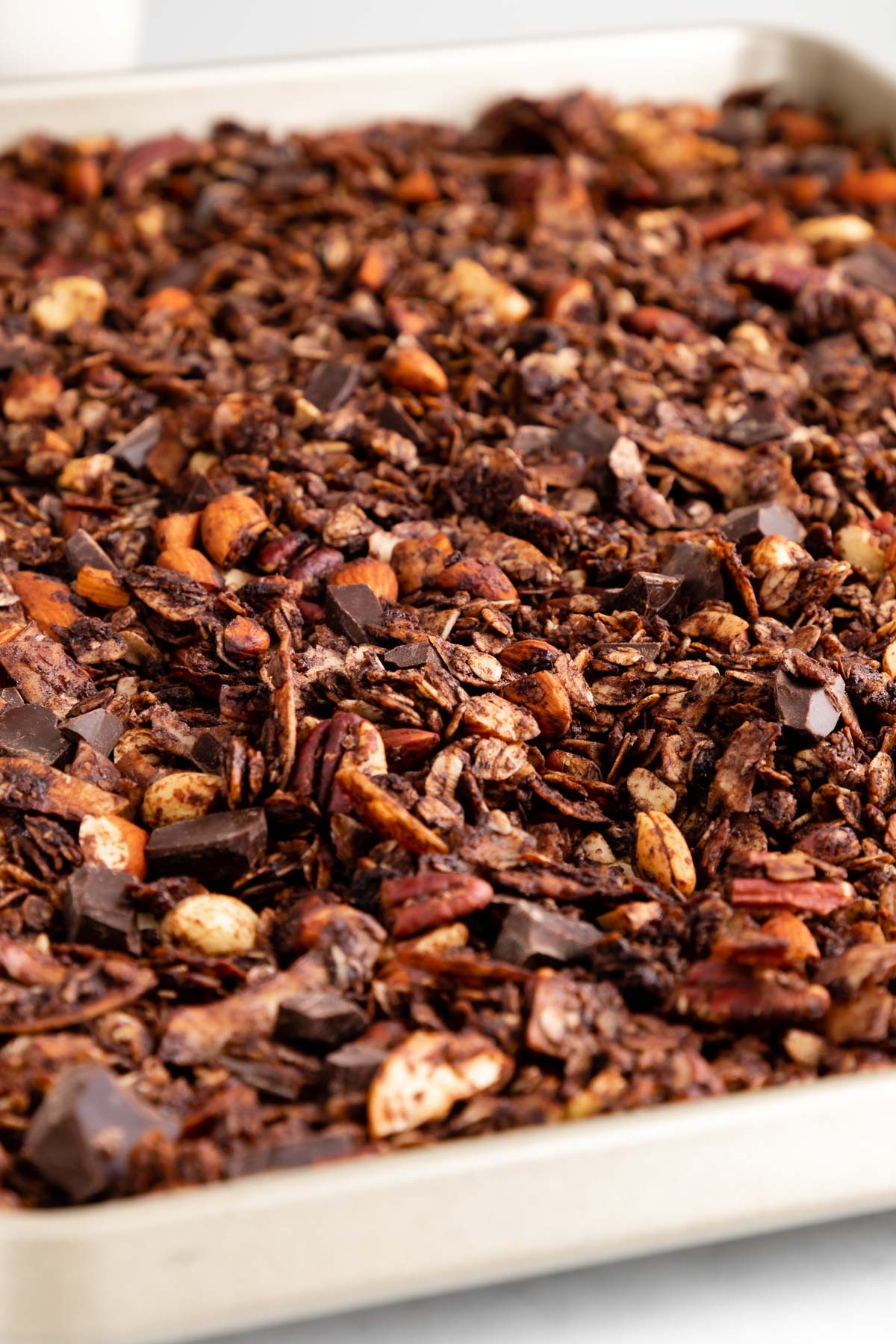 homemade chocolate coconut granola on a baking sheet