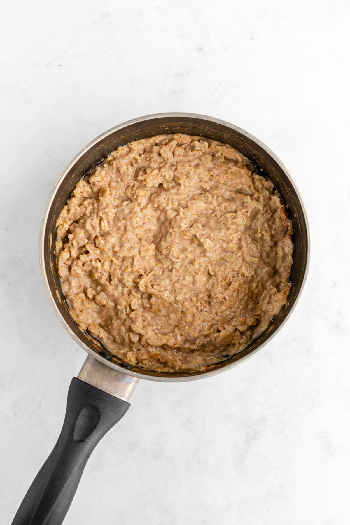 cooking stovetop almond butter oatmeal in a pot