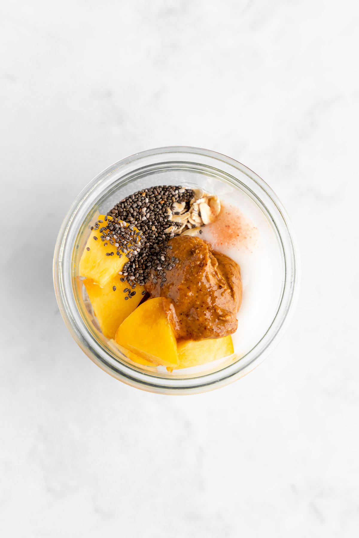 ingredients for peaches and cream overnight oats in a jar