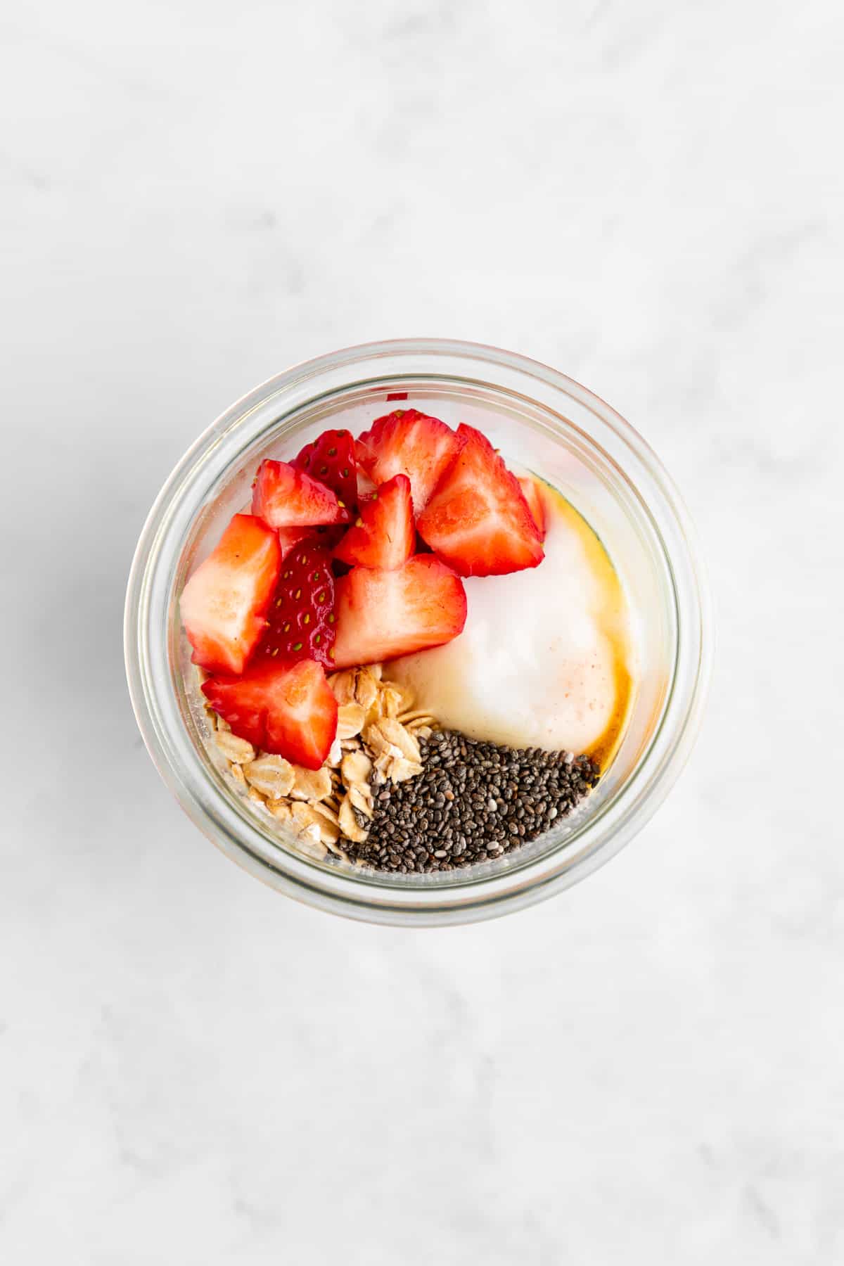 ingredients for strawberries and cream overnight oats in a mason jar
