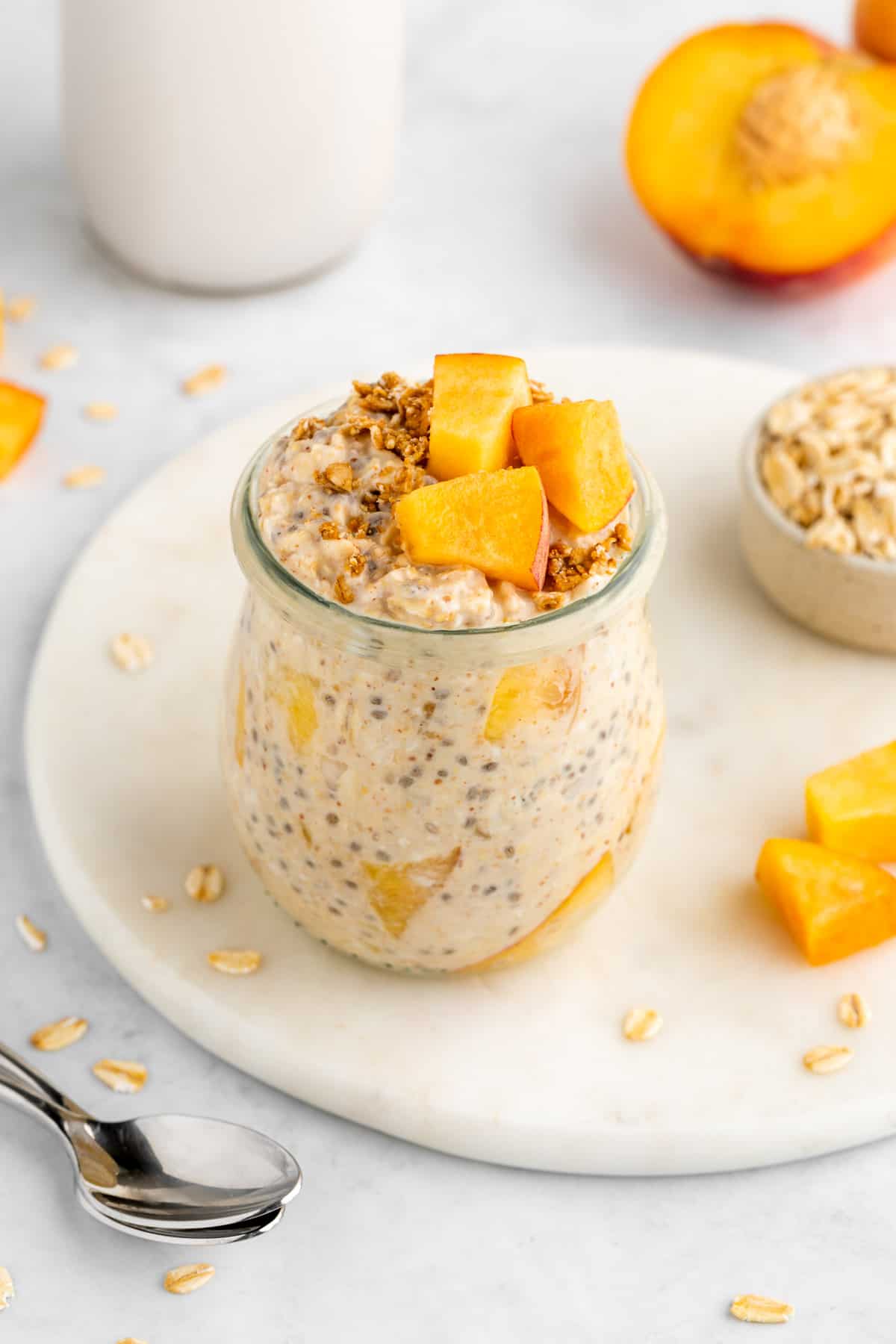 peaches and cream overnight oats in a jar with yogurt
