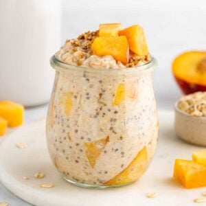 peaches and cream overnight oats in a jar with yogurt and chia seeds