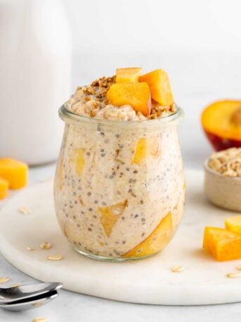 peaches and cream overnight oats in a jar with yogurt and chia seeds