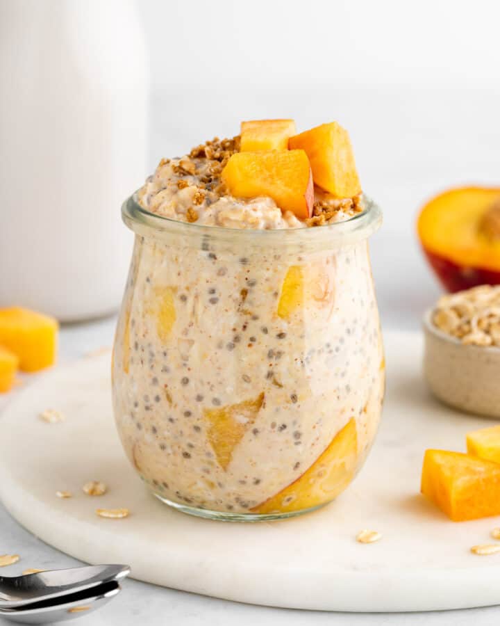 peaches and cream overnight oats in a jar with yogurt and chia seeds