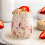 strawberries and cream overnight oats in a jar with yogurt
