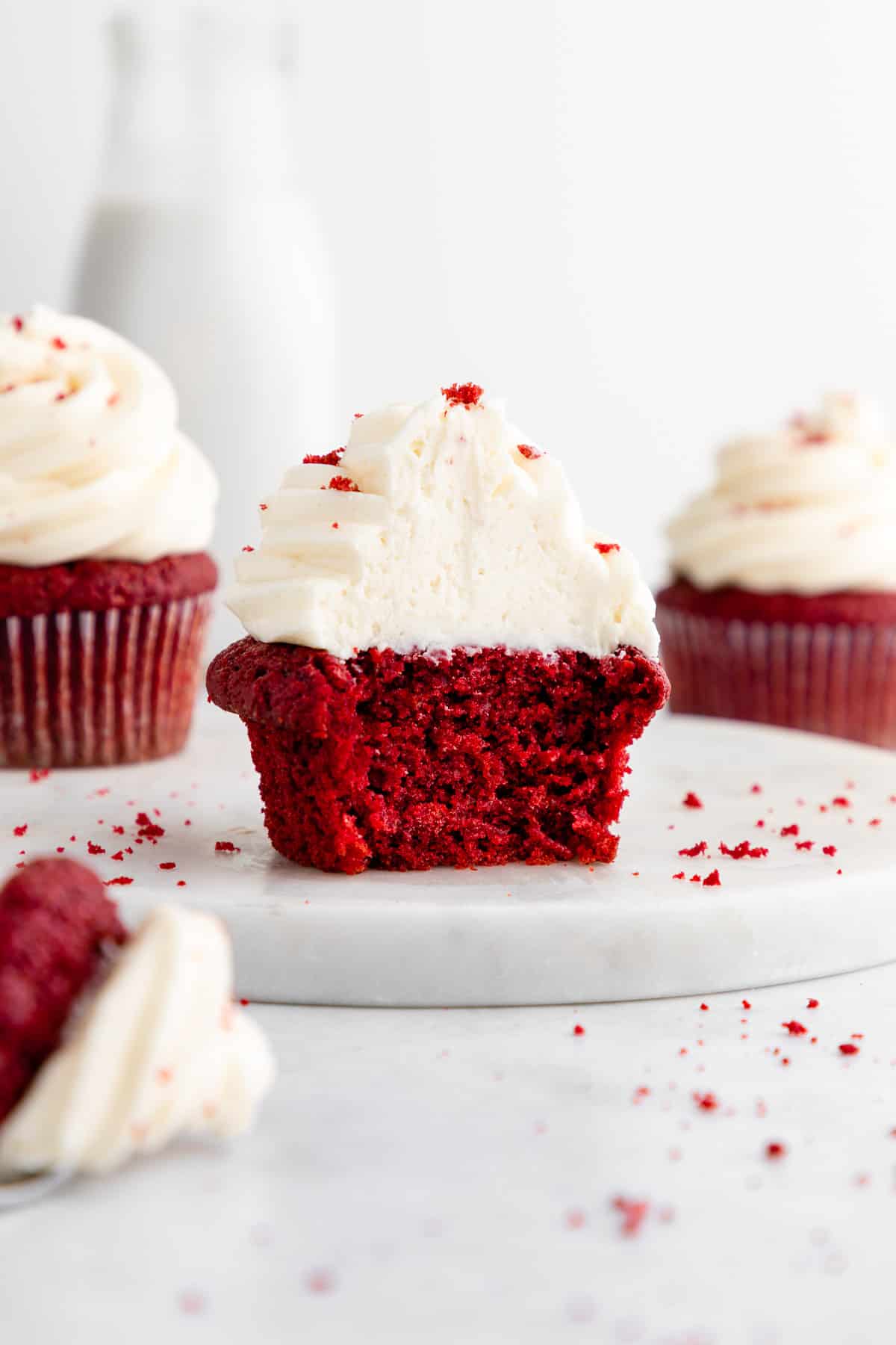vegan red velvet cupcakes with a bite taken out of the center one