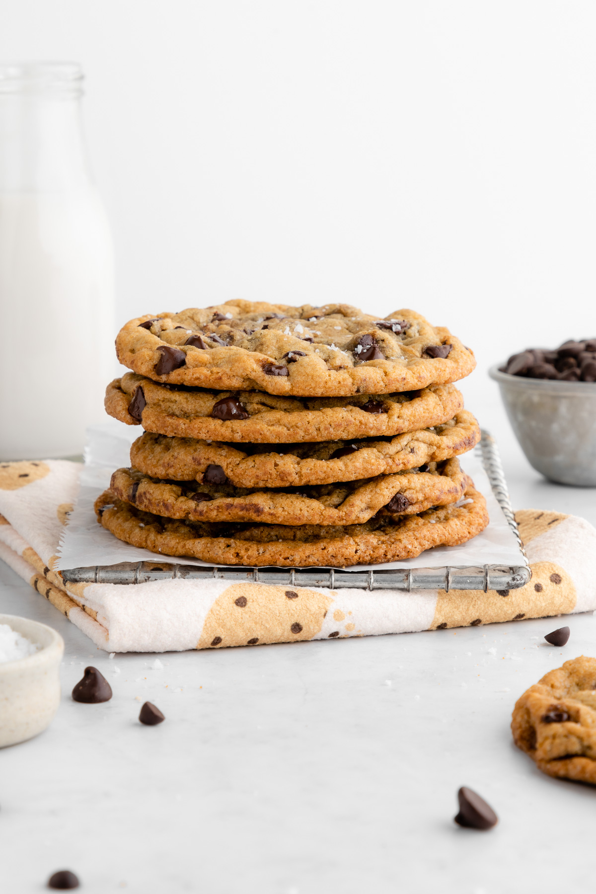 a stack of chocolate chip cookies on top of a geometry kitchen towel