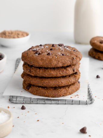 a stack of vegan chocolate protein cookies on a wire baking rack