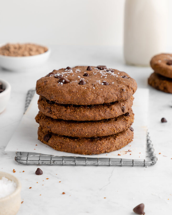 a stack of vegan chocolate protein cookies on a wire baking rack
