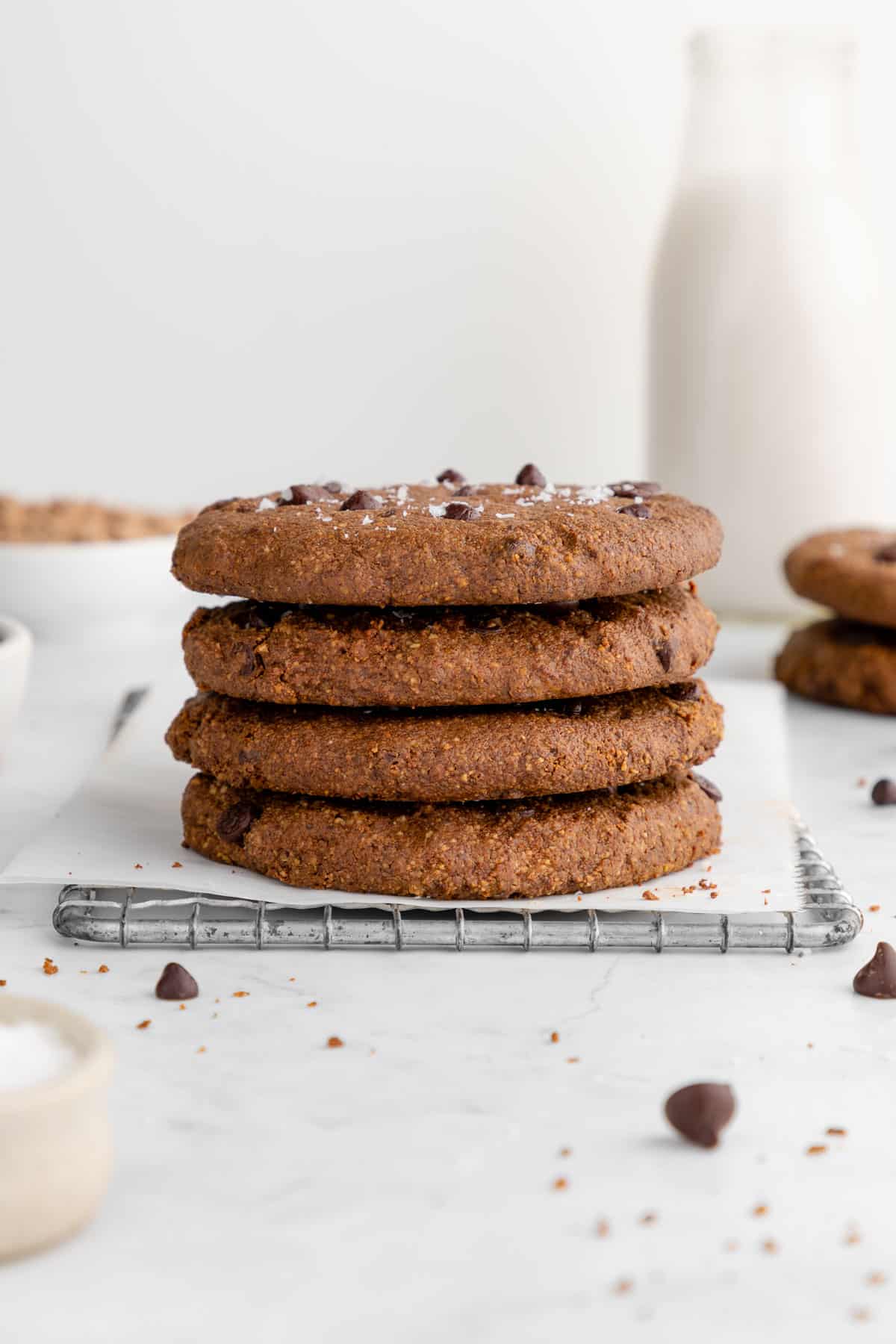 a stack of vegan chocolate chip protein cookies on a wire baking rack