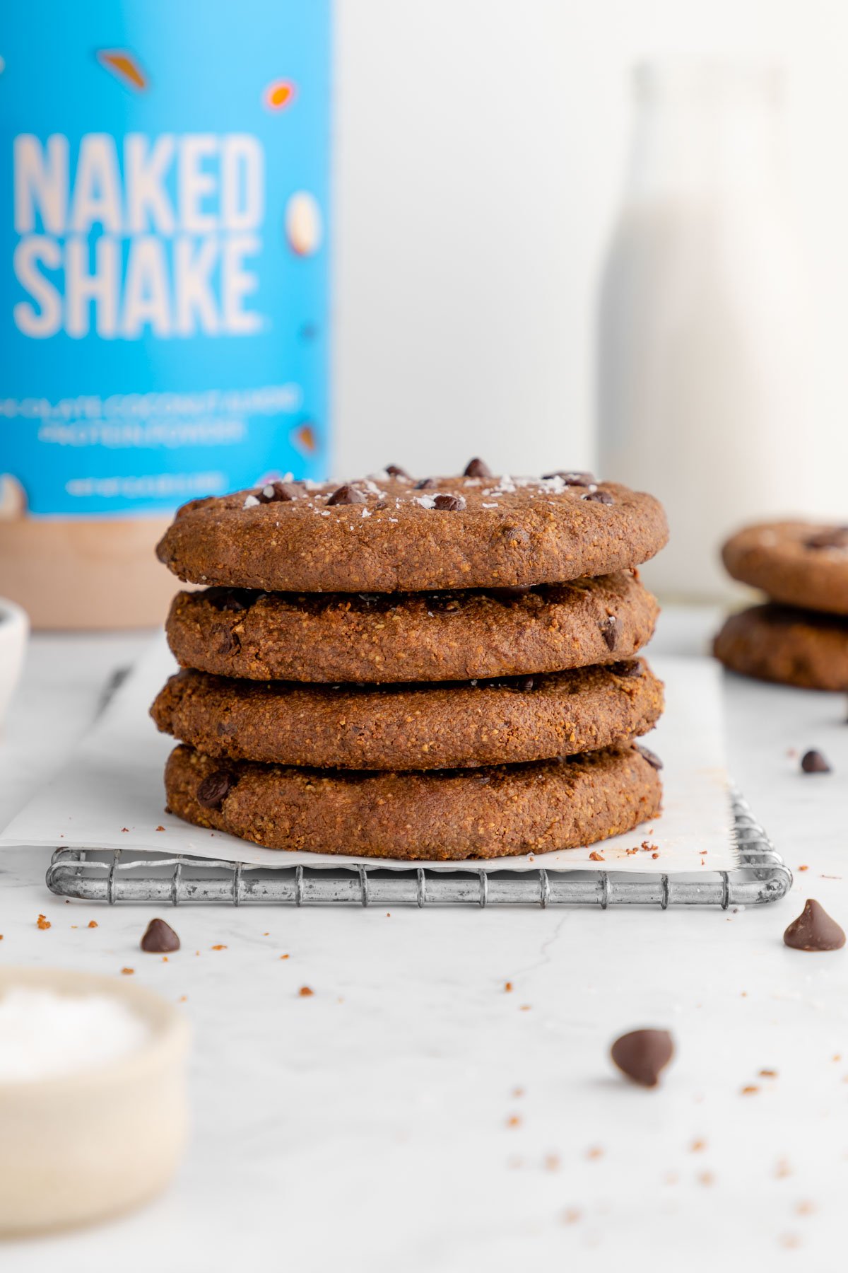 a stack of vegan chocolate chip protein cookies on a wire baking rack