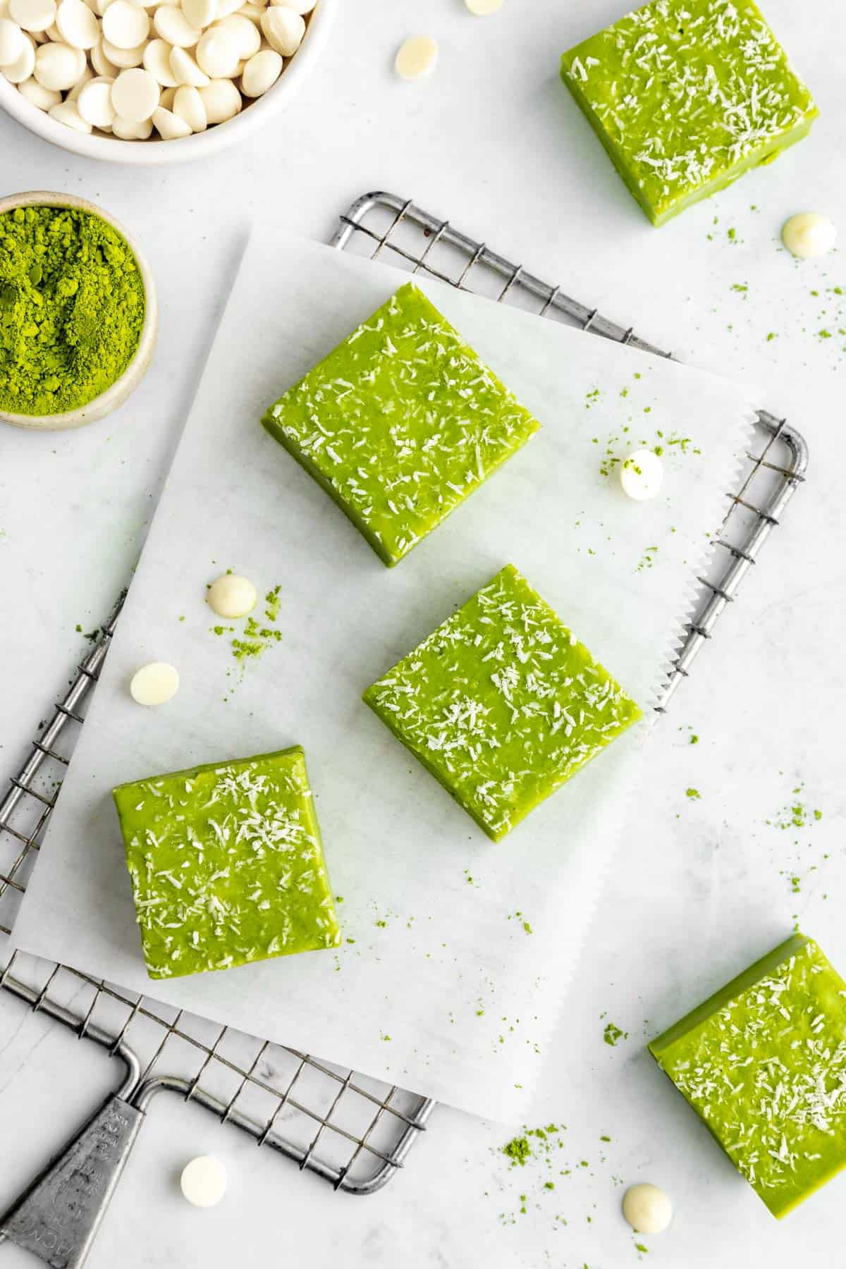 white chocolate matcha fudge squares on a wire baking rack