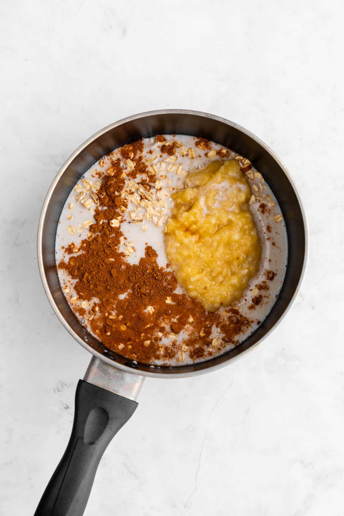 cooking banana oatmeal inside a black pot