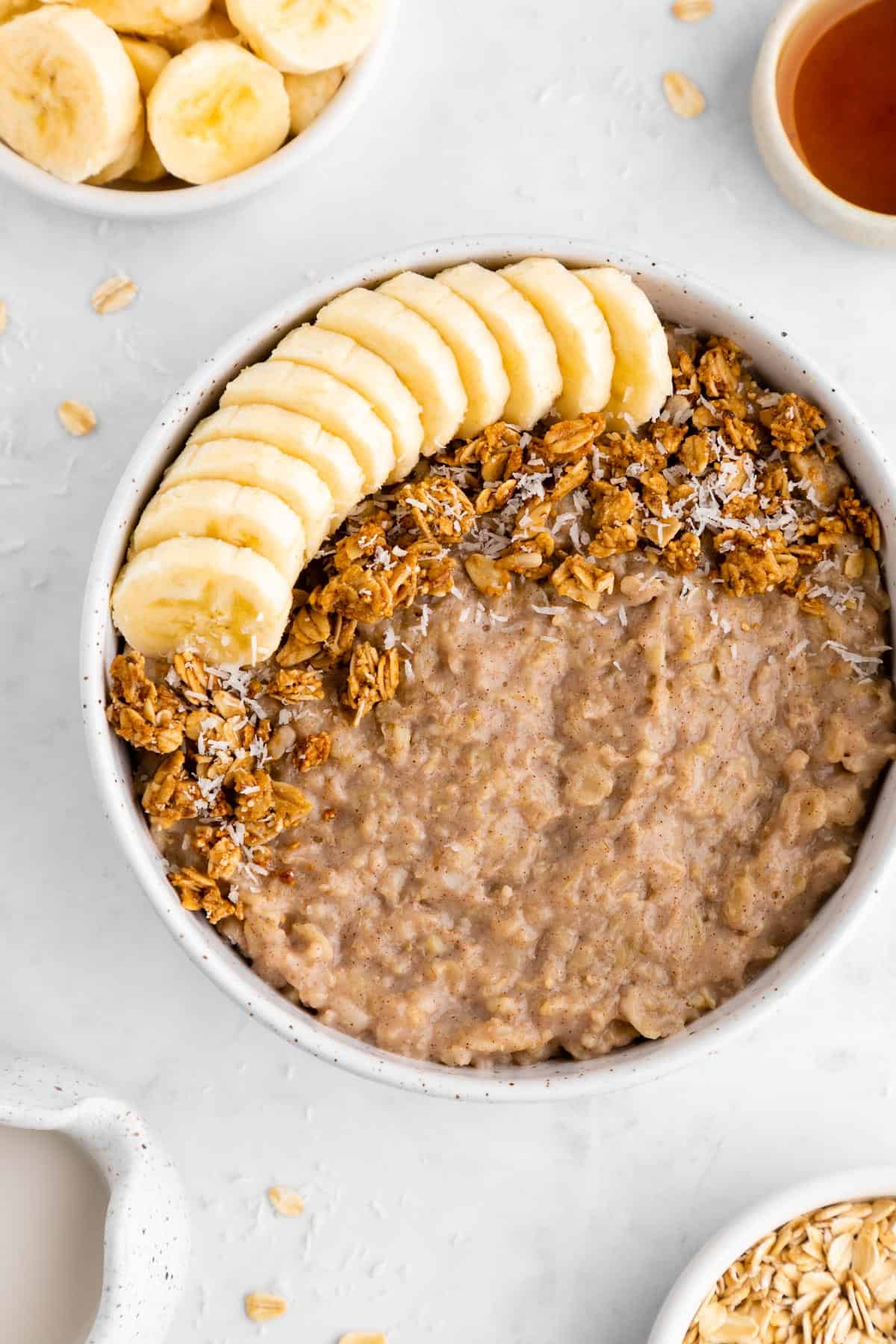 simple banana oatmeal inside a speckled ceramic bowl