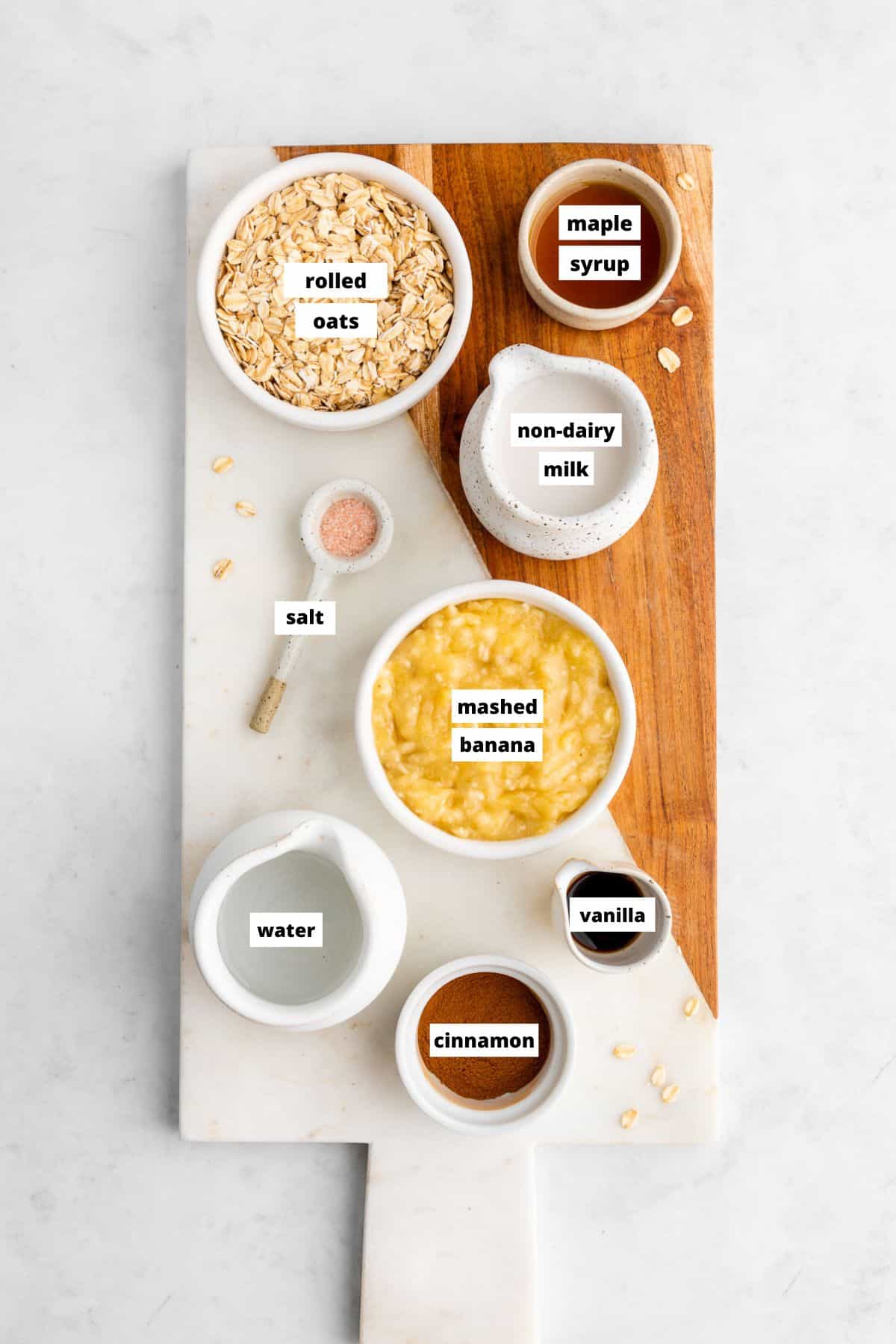 ingredients for banana oatmeal on a wooden cutting board