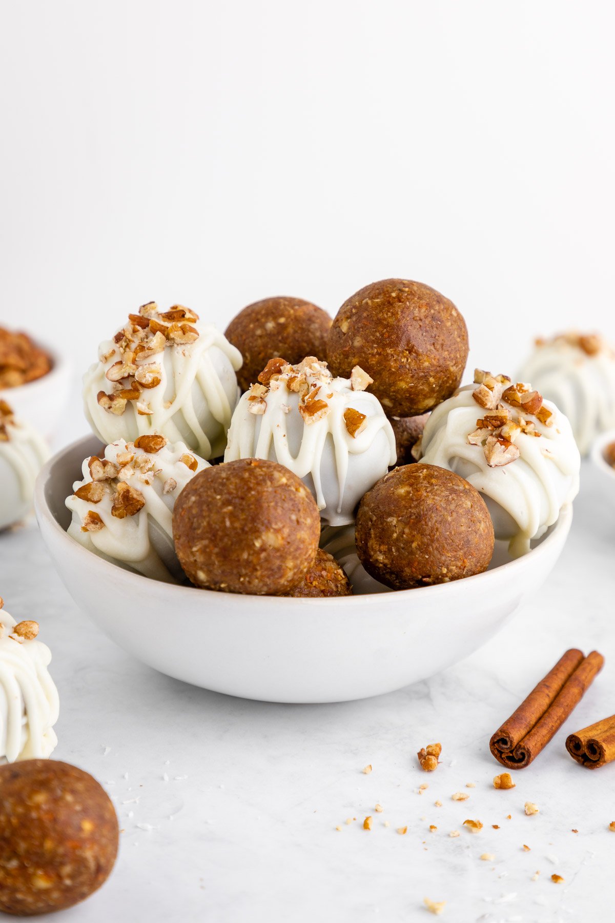 a bowl of no-bake carrot cake truffles with white chocolate