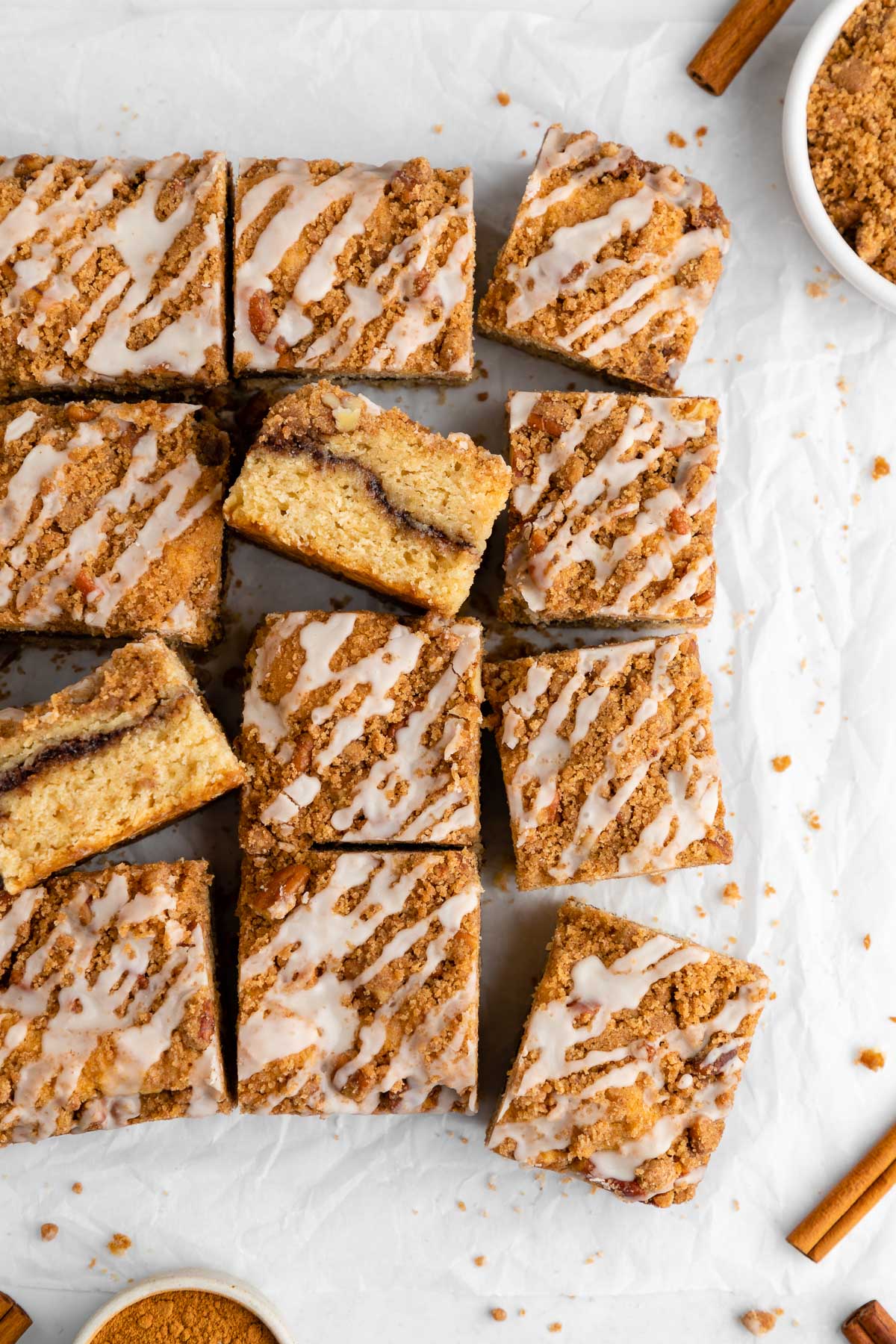 a pile of sliced vegan cinnamon roll coffee cake with vanilla glaze