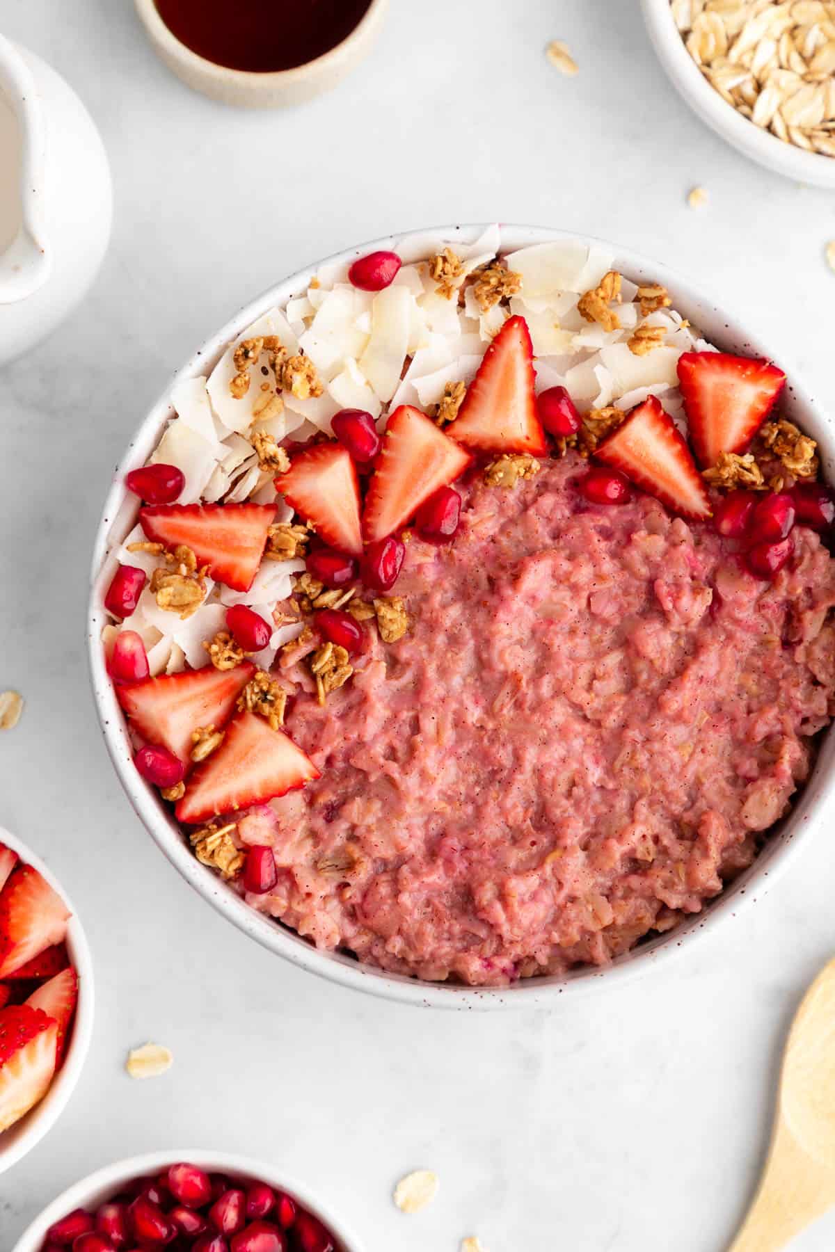 a close up of strawberry oatmeal inside a ceramic bowl