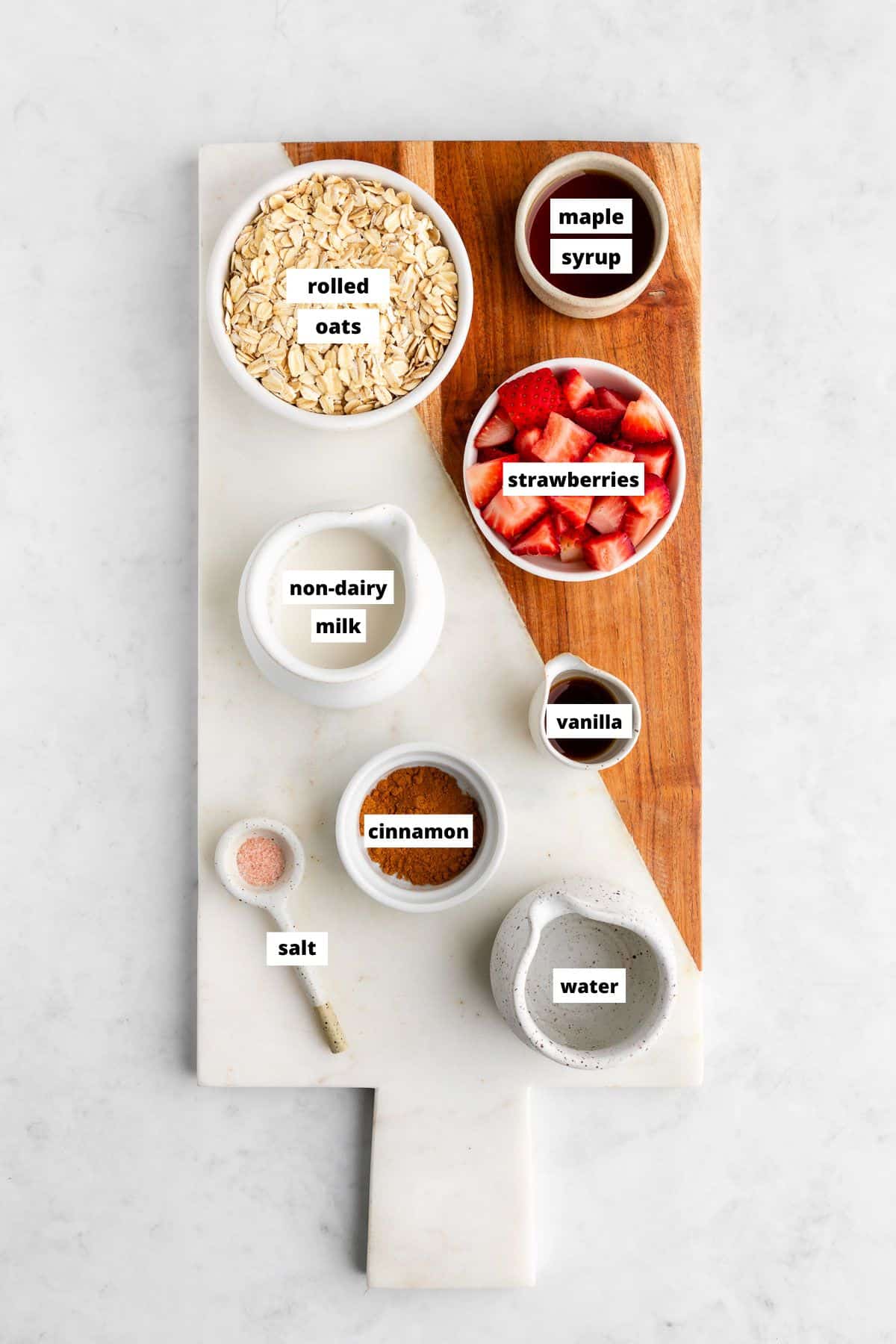 strawberry oatmeal ingredients on a marble serving board