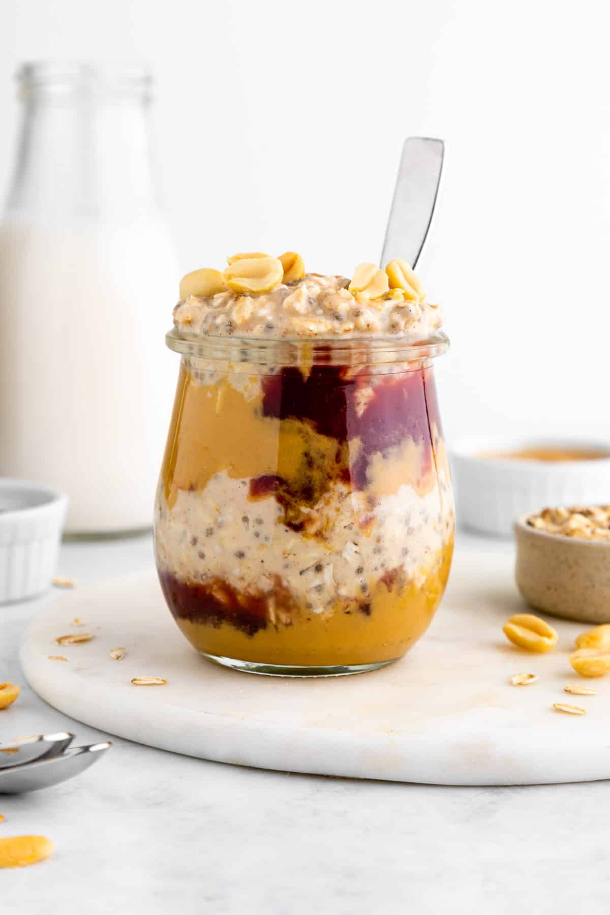 pb and j overnight oats inside a glass weck jar with a spoon