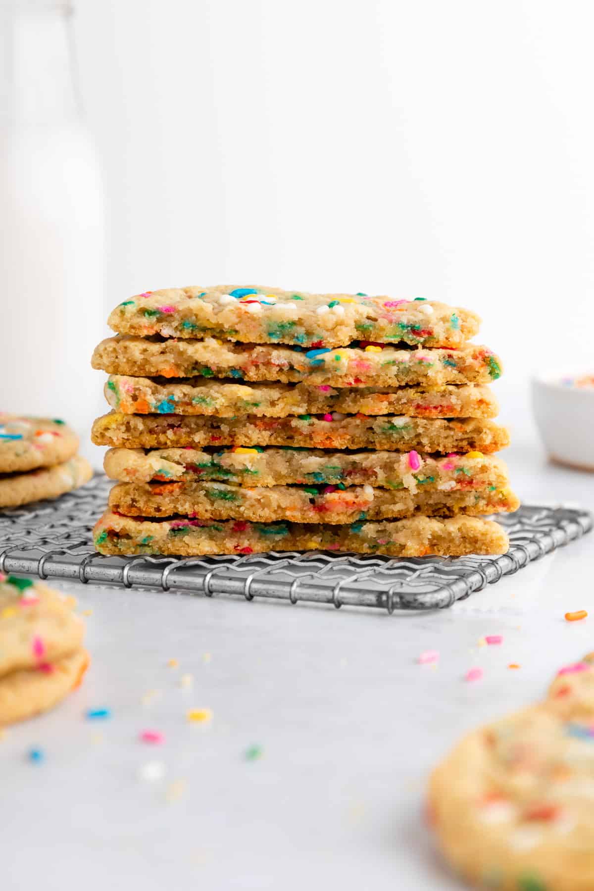 a stack of soft and chewy vegan funfetti cookies cut in half