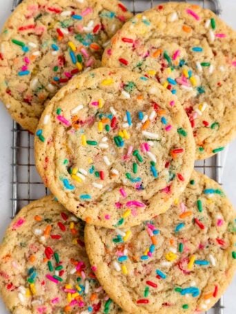 close up of vegan funfetti cookies on a wire cooling rack