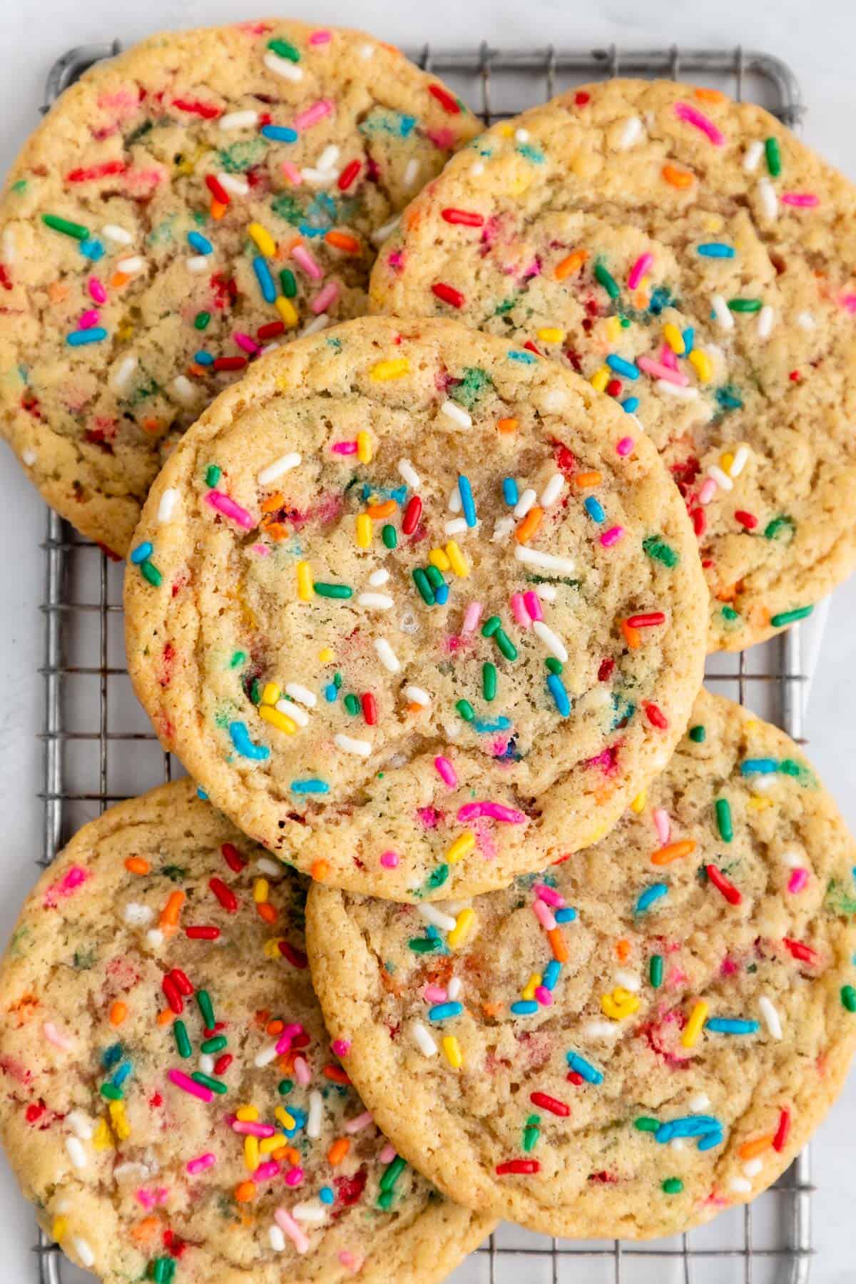close up of vegan funfetti cookies on a wire cooling rack