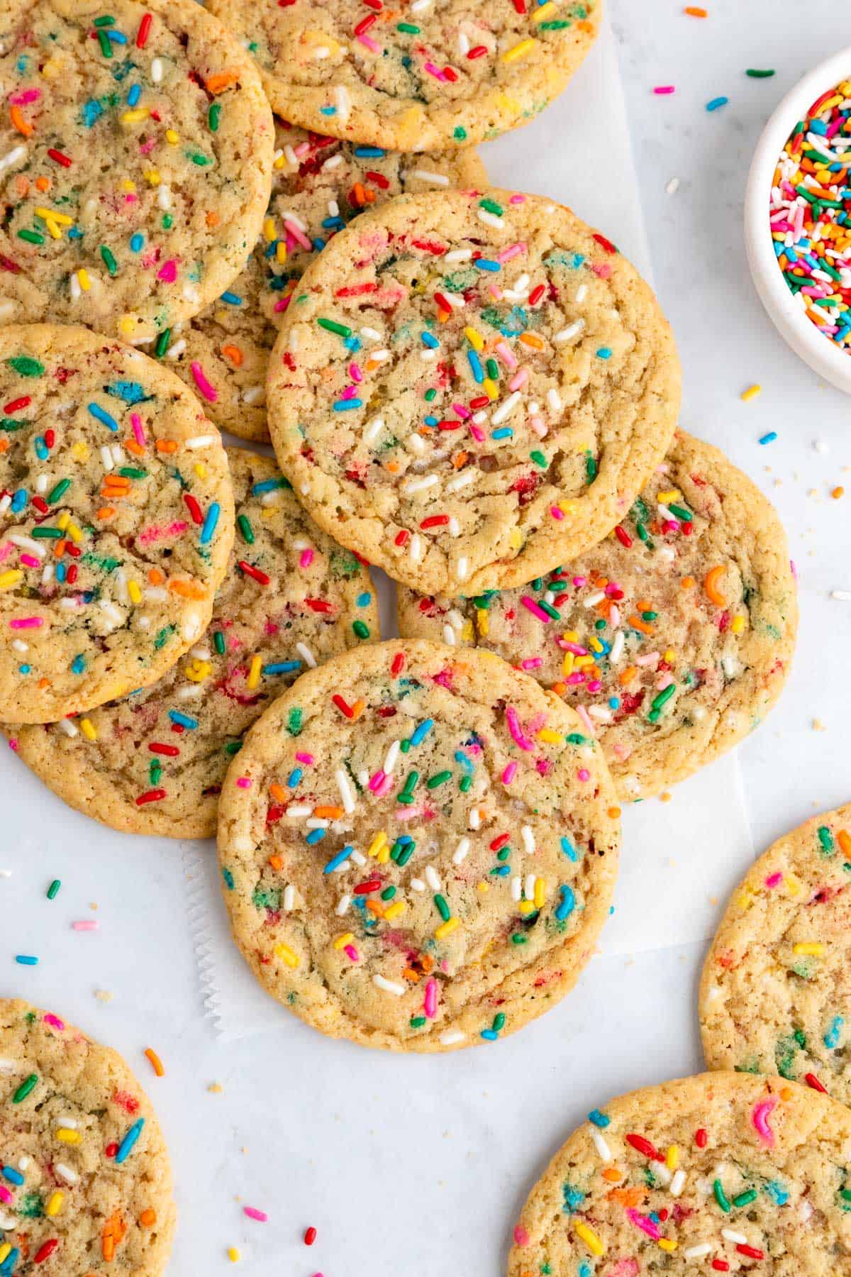 a pile of vegan funfetti cookies with sprinkles