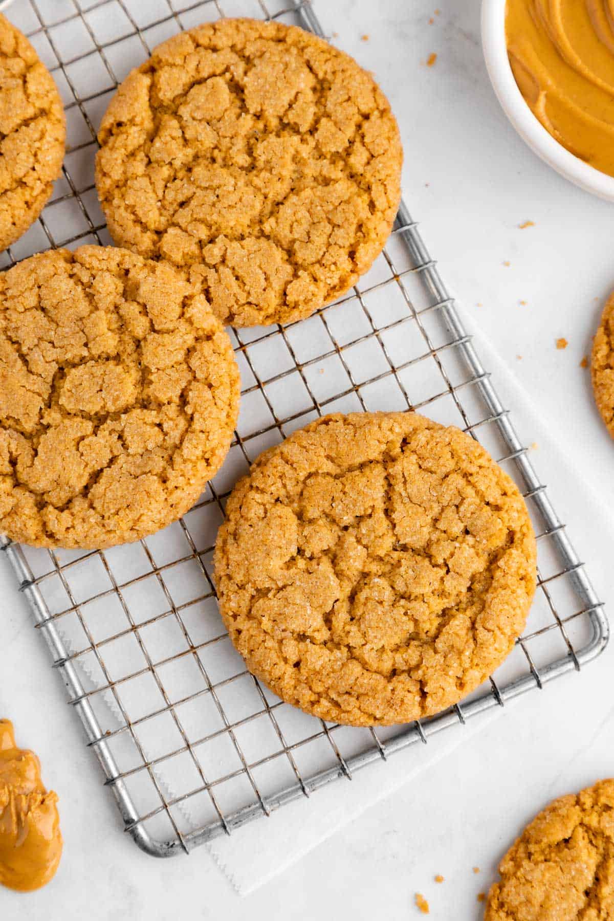 a pile of vegan peanut butter cookies on a wire rack