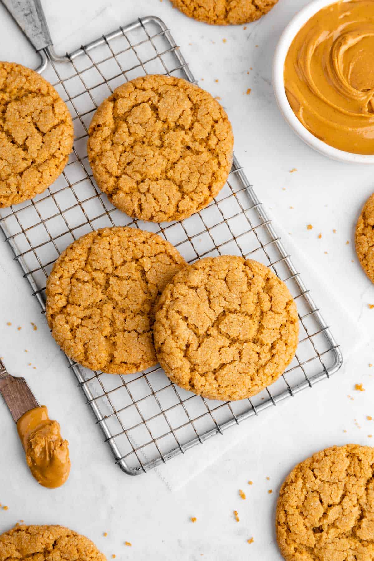 a pile of vegan peanut butter cookies on a wire rack