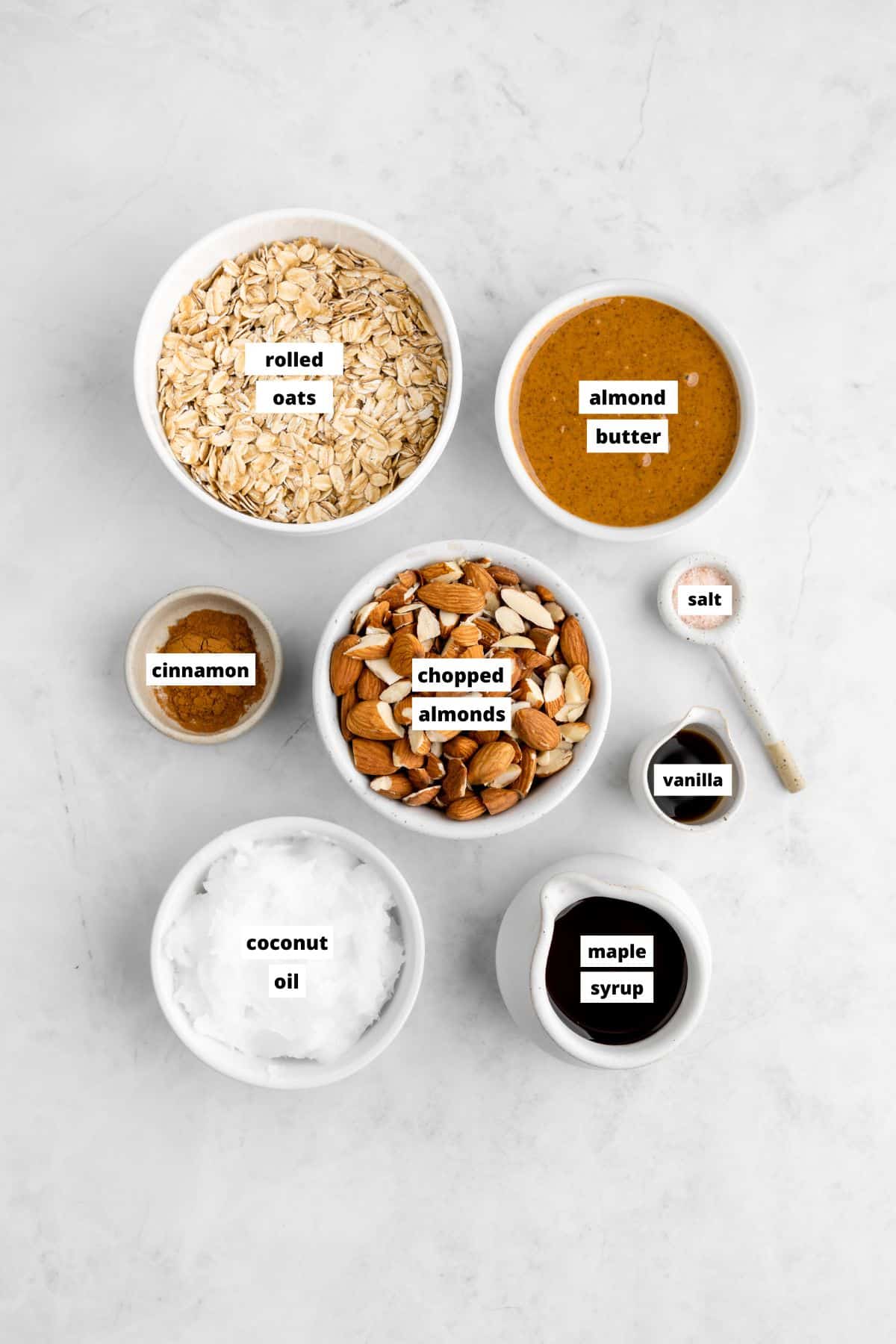 bowls of ingredients for homemade almond butter granola