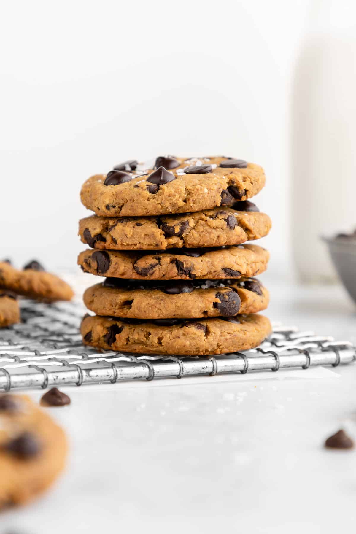 a stack of five chickpea chocolate chip cookies on a wire cooling rack