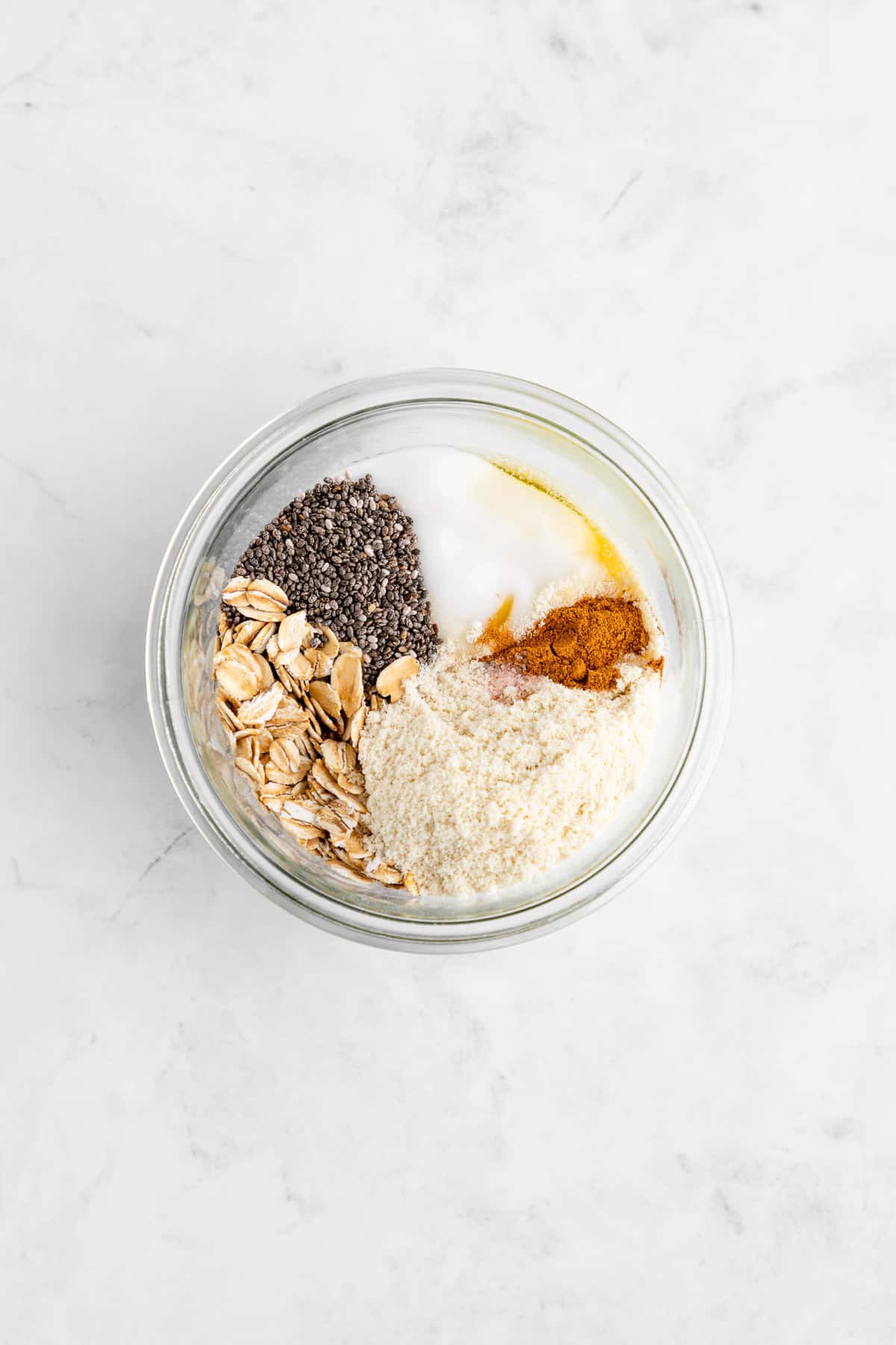 ingredients for protein overnight oats inside a glass mason jar