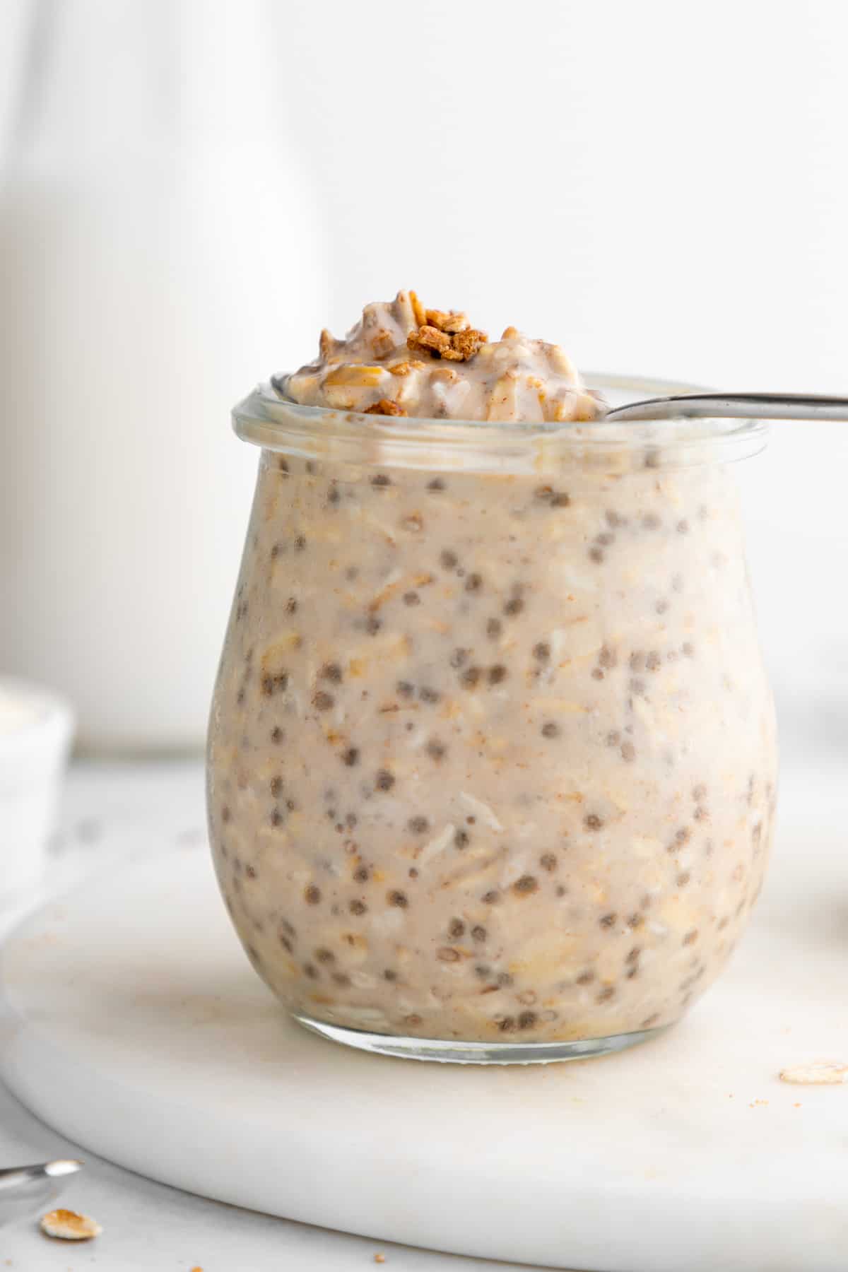 a spoon scooping protein overnight oats out of a jar