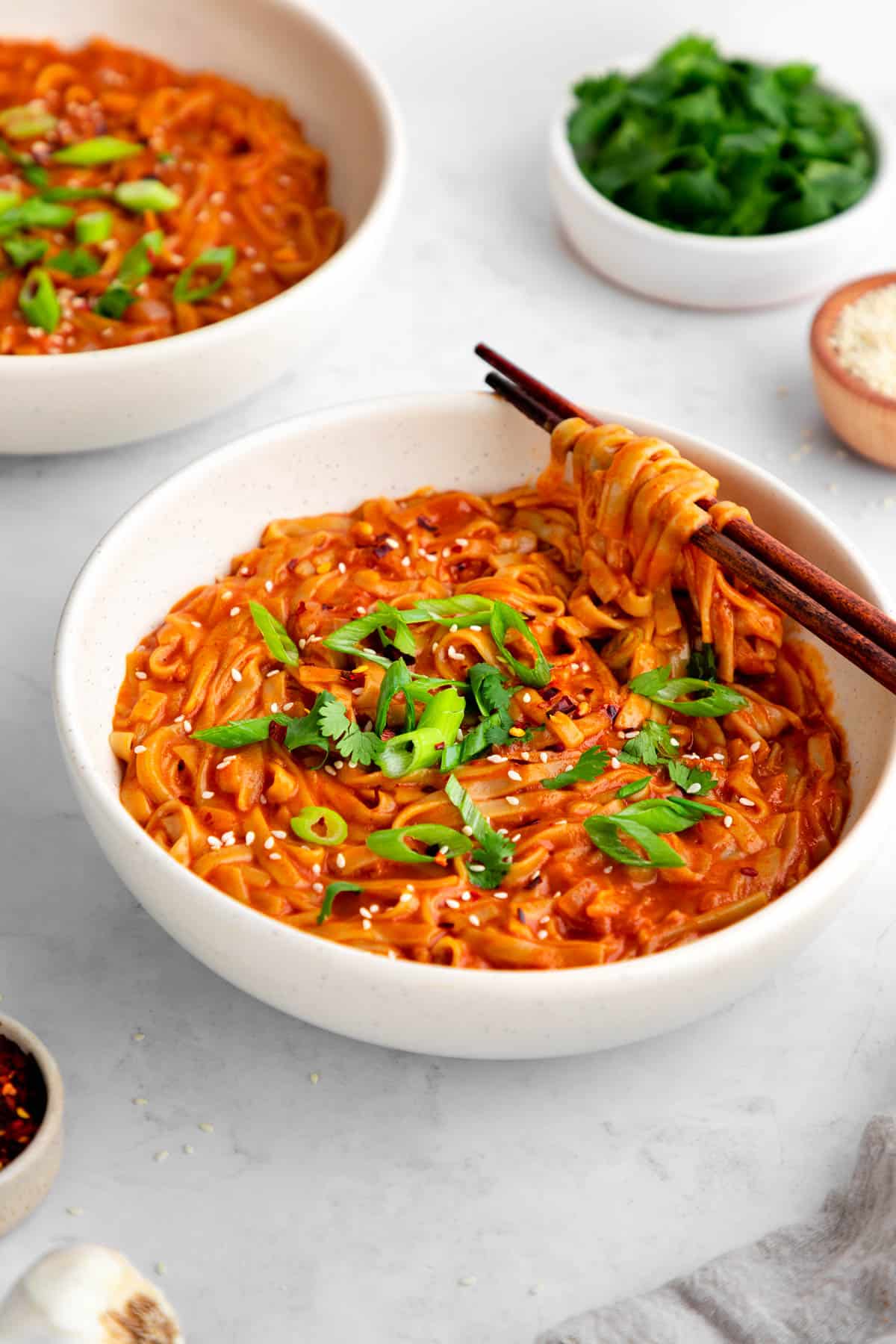a bowl of vegan red curry noodles with chopsticks