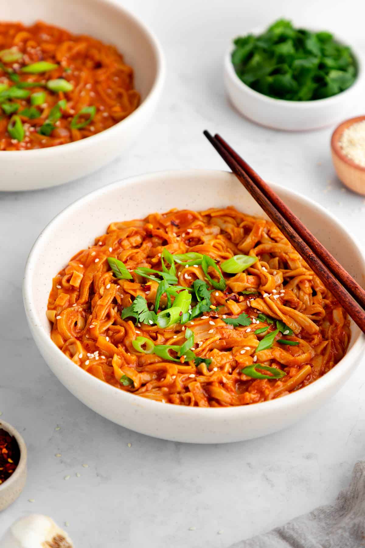 vegan red curry noodles in a bowl with chopsticks