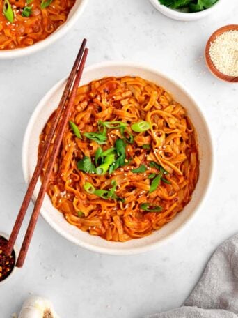 vegan red curry noodles in a bowl with chopsticks