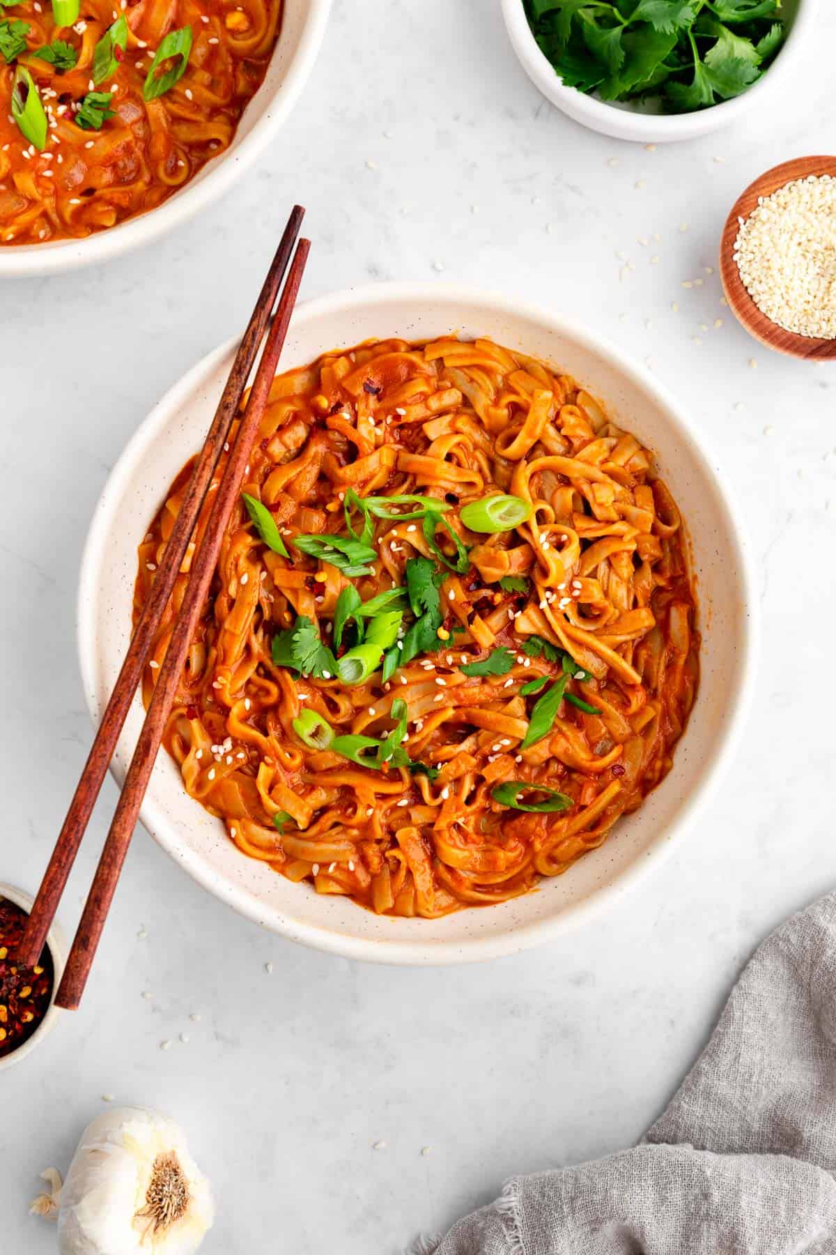 vegan red curry noodles in a bowl with chopsticks