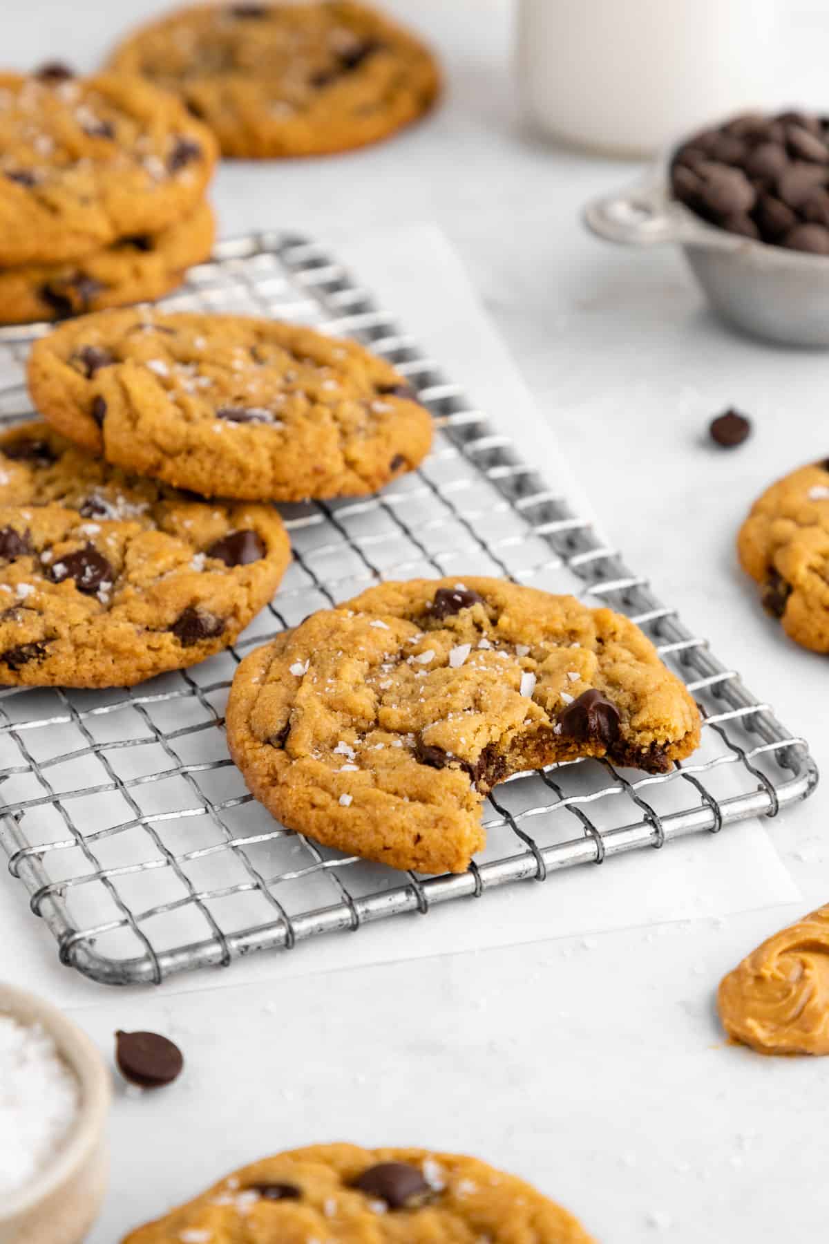 a vegan peanut butter chocolate chip cookie with a bite taken out of the middle