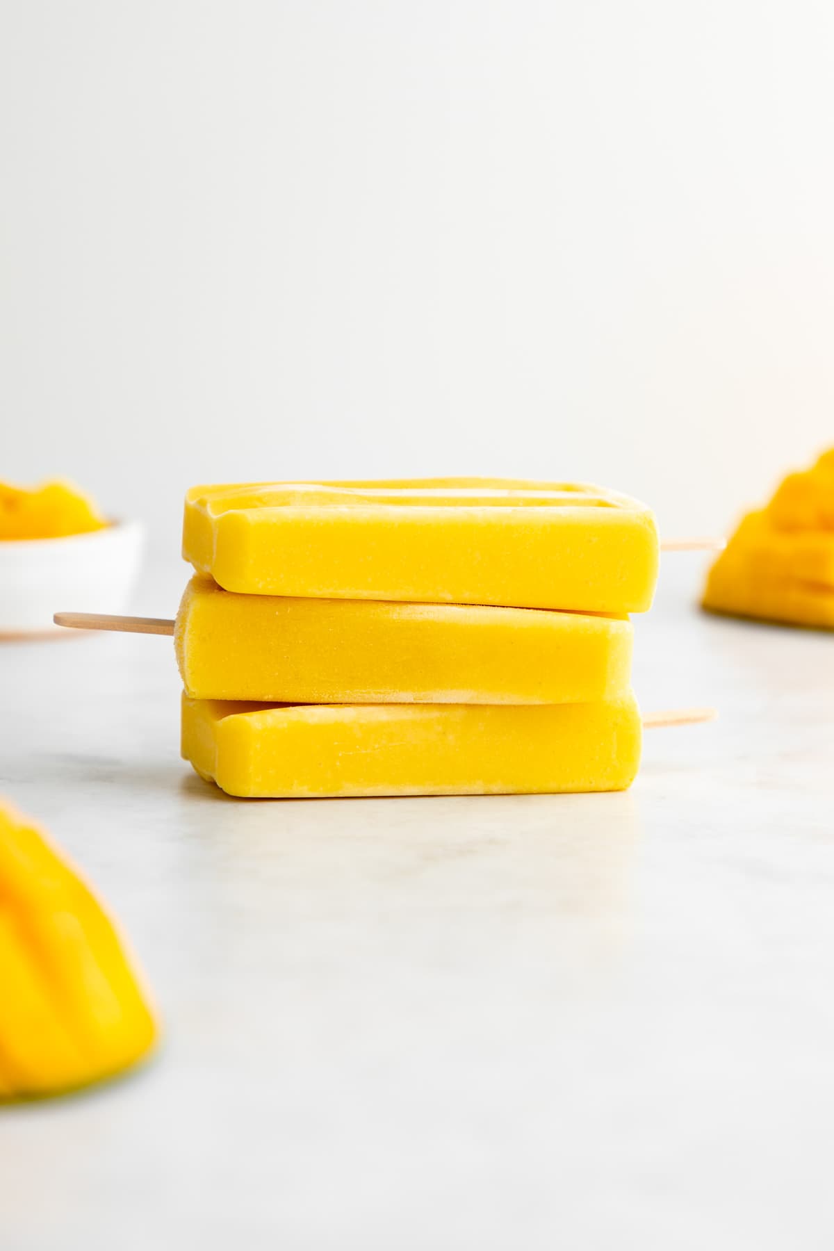 a stack of three mango lassi popsicles