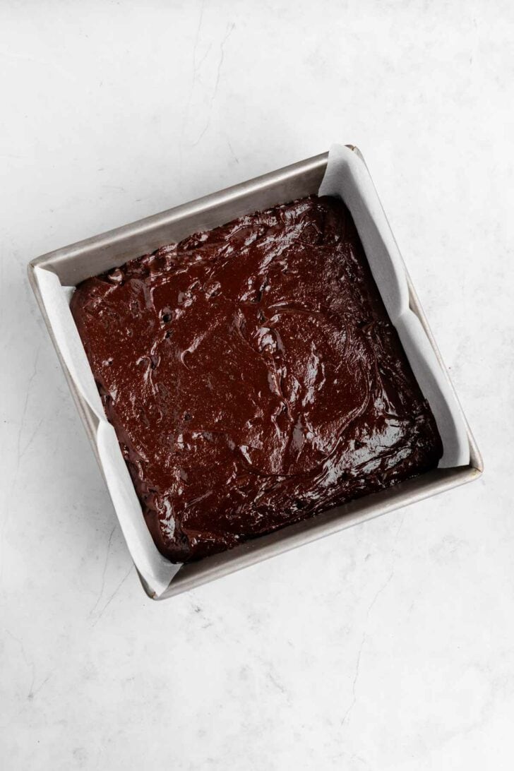 vegan peppermint brownies batter inside a square baking dish