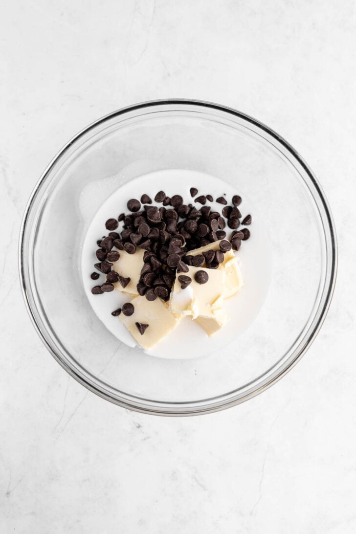 coconut milk, chocolate chips, and vegan butter inside a glass mixing bowl