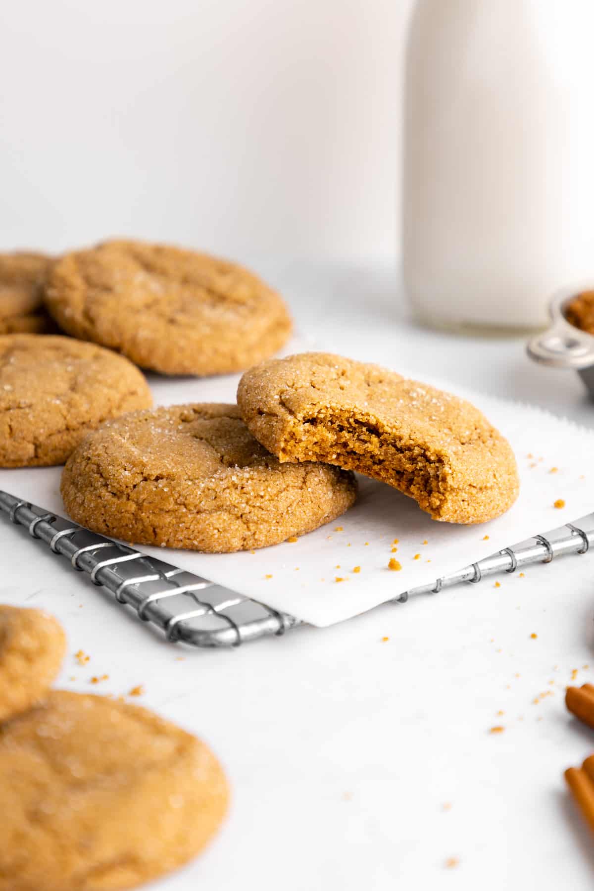 vegan brown sugar cookies on a wire cooling rack with a bite taken out of one