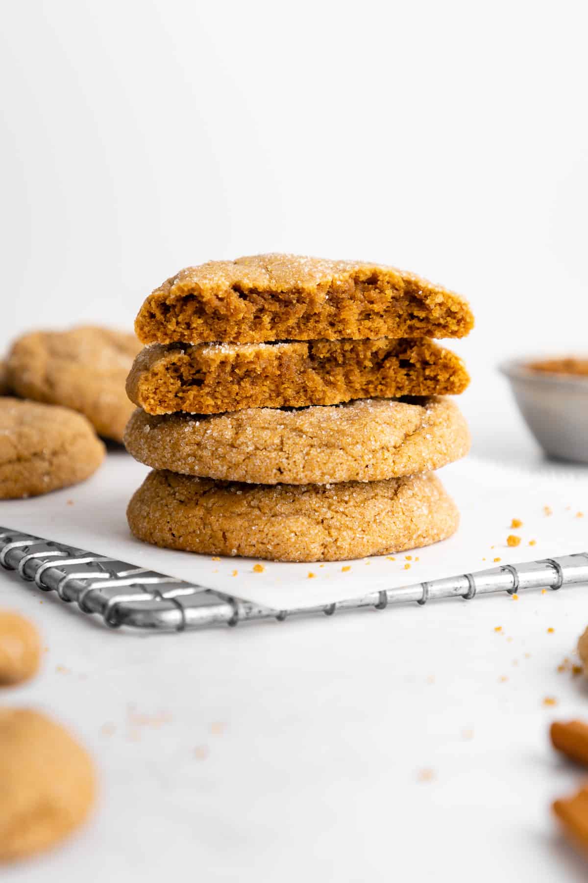 a stack of vegan brown sugar cookies with the top two showing the cross section