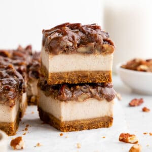 a stack of two vegan pecan pie cheesecake bars