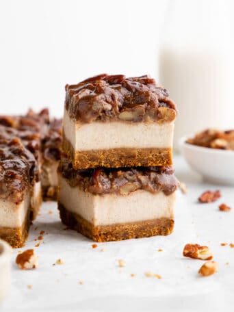 a stack of two vegan pecan pie cheesecake bars