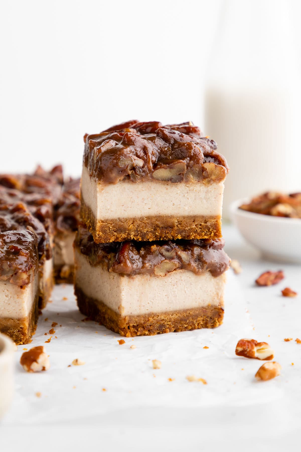 a stack of two vegan pecan pie cheesecake bars